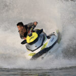 Teenager_riding_a_jetski_splashing_on_the_Mekong