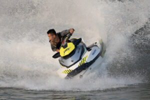 Teenager_riding_a_jetski_splashing_on_the_Mekong
